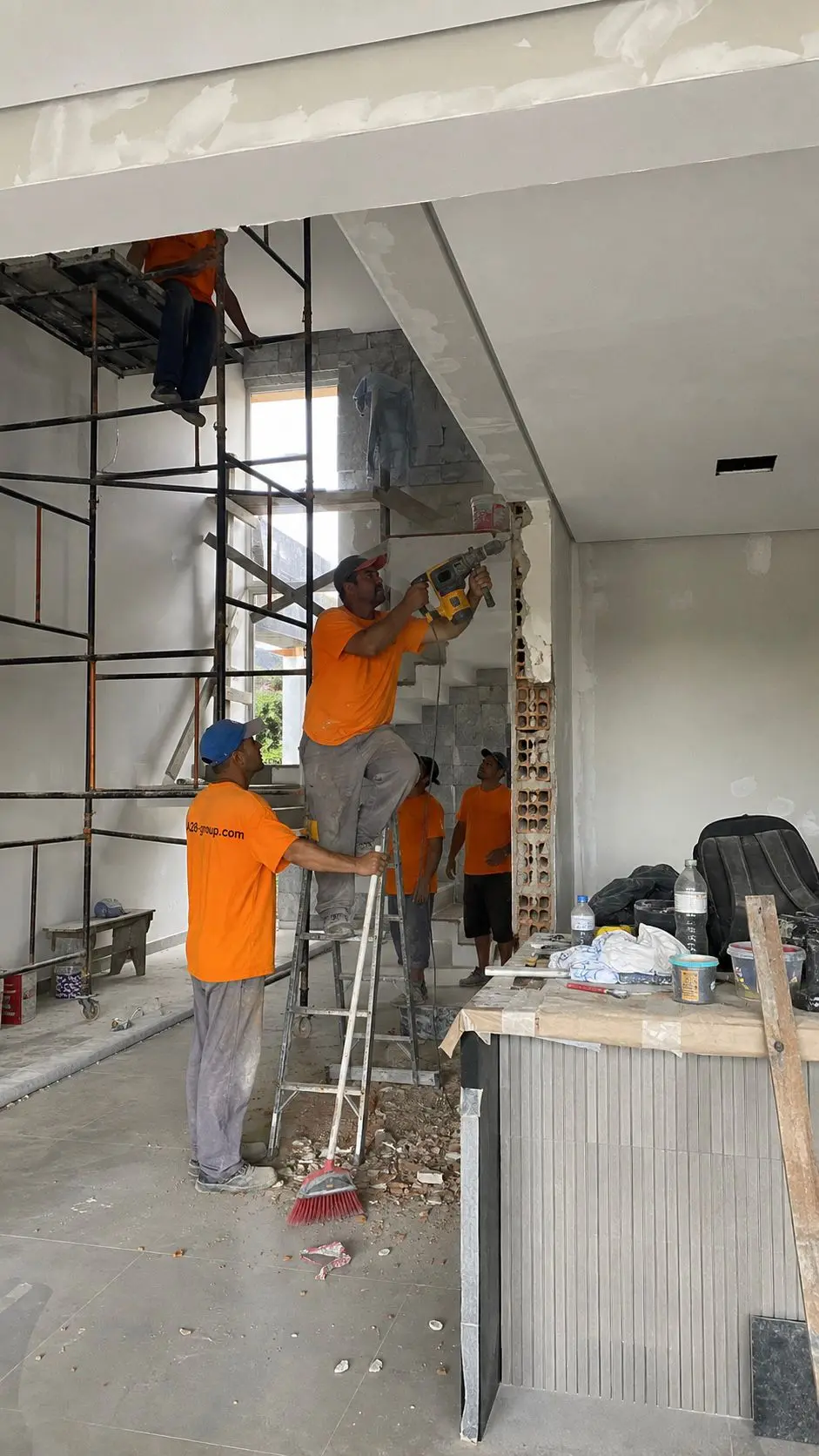 Concrete facade of a new build under way, with scaffolding in the foreground