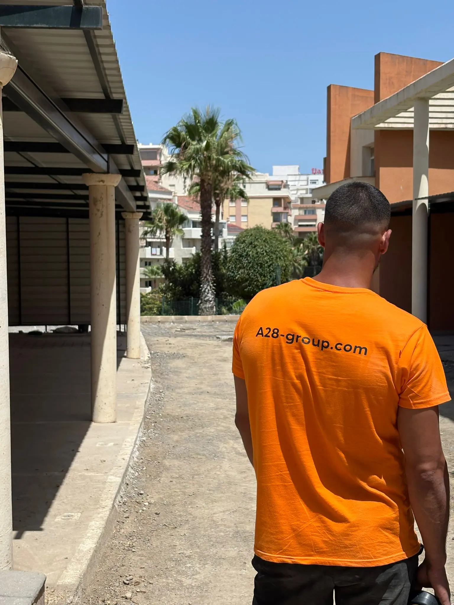 An A28 Group team member, seen from behind, on a building site in Marbella